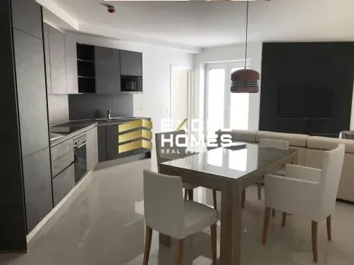 a kitchen with a table and chairs and a refrigerator