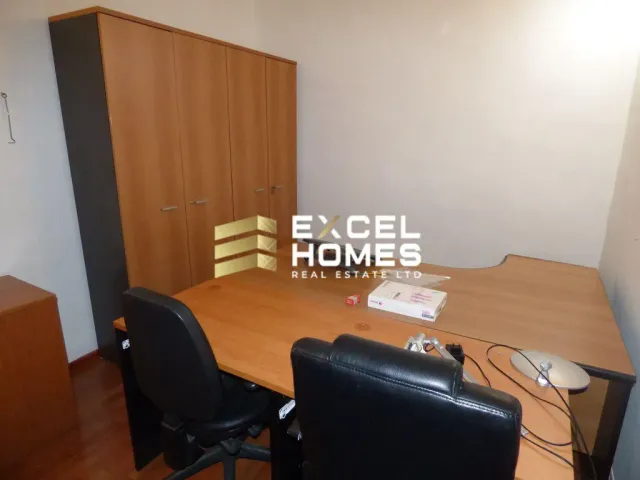 a desk with a chair and a computer