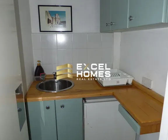 a kitchen counter with a sink and a microwave
