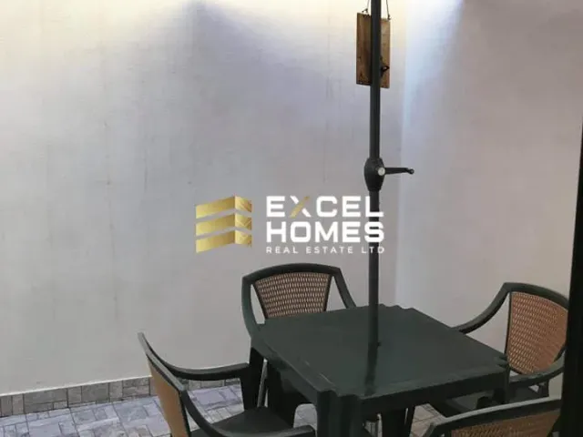 a lamp post with a table and chairs