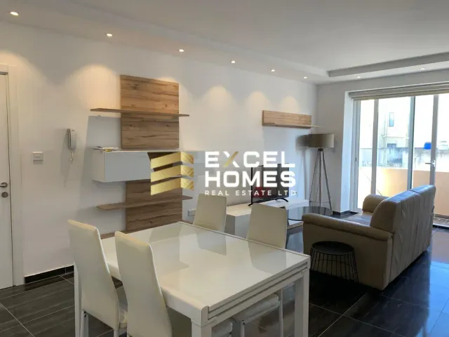 a living room with a table and chairs 