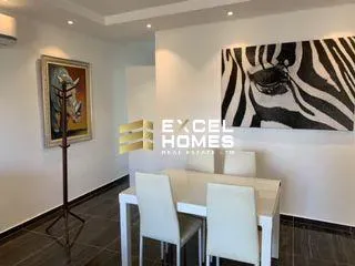 a living room with a painting on the wall 
