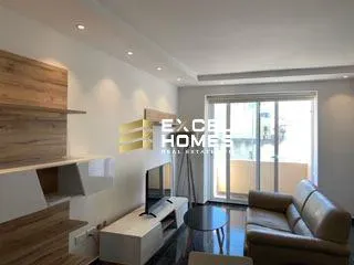 a living room with a couch, coffee table and a tv 