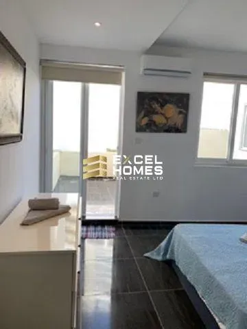 a room with a bed, a desk and a window 