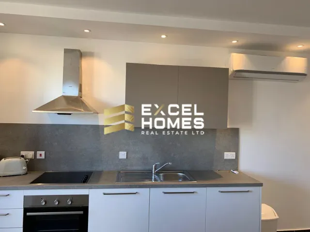 a kitchen with a white refrigerator and a black counter top 