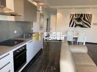 a kitchen with a white counter top and a white refrigerator 