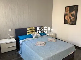 a bed with a white bedspread and a blue and white bedspread 