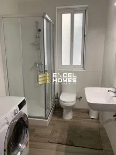 a bathroom with a toilet, sink, and shower 