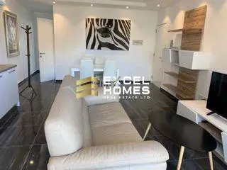 a living room with a couch, table, and television 