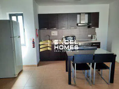 a kitchen with a table and chairs and a refrigerator 