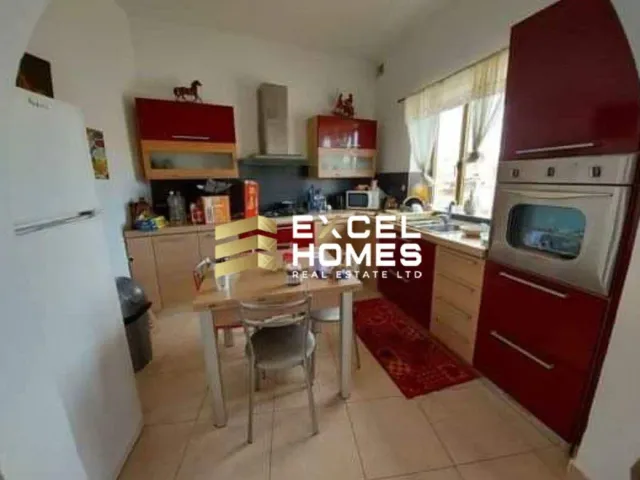 a kitchen with a stove, sink, and refrigerator