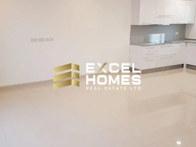 a kitchen with a white refrigerator and a white counter top