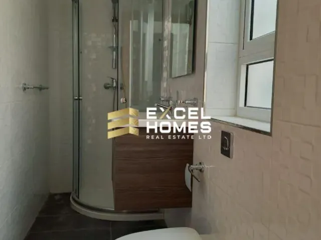 a bathroom with a shower, sink, and mirror