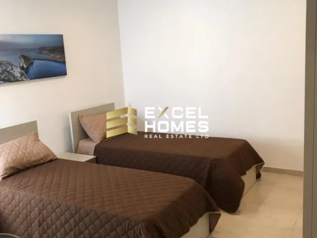 a bed room with two beds and a desk 
