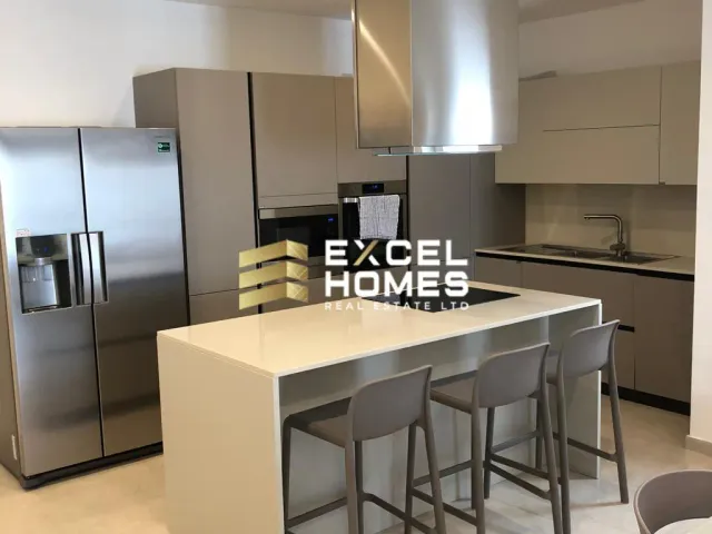 a kitchen with a refrigerator, sink, and counter top 