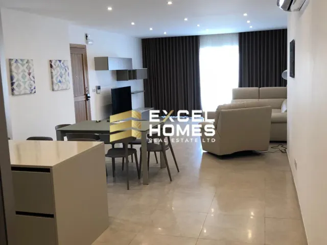 a living room with a table and chairs 