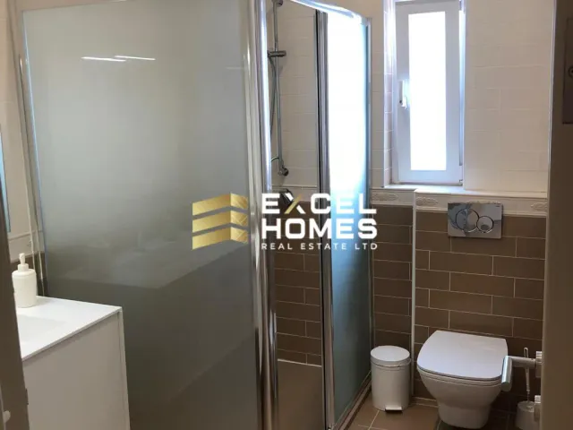 a bathroom with a toilet, shower, and sink 