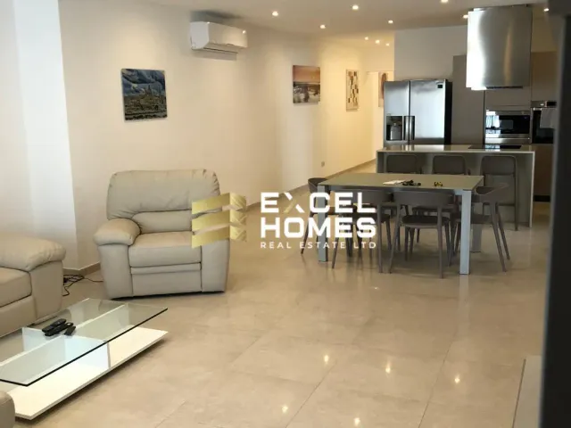 a living room with a couch, table, chairs and a television 
