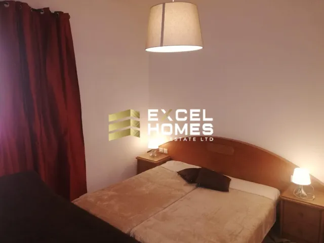 a bed with a lamp and a night stand 