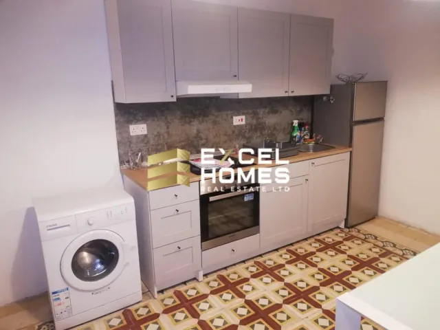 a kitchen with a stove, microwave, and refrigerator 