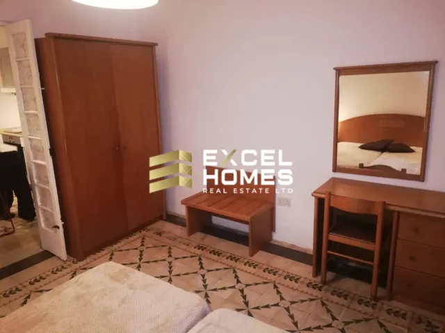 a room with a mirror and a chair 
