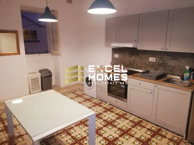 a kitchen with a stove, sink, and refrigerator 