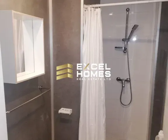 a shower stall with a shower curtain and a shower head 