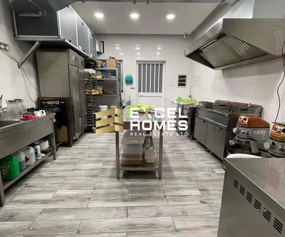 a kitchen with a stove, oven, and a counter