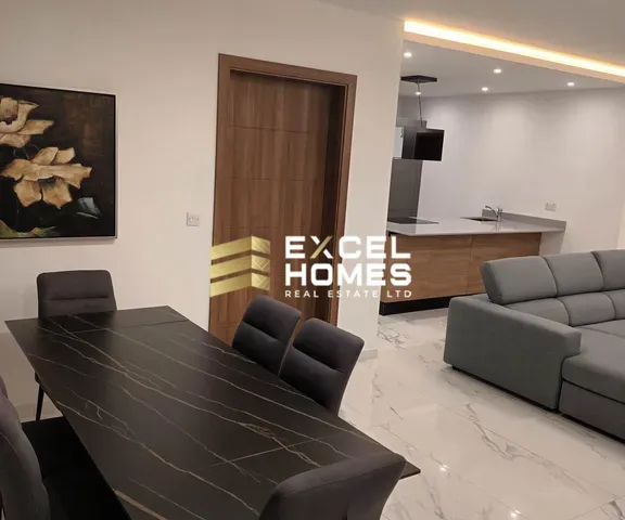 a living room with a couch, table, chairs and a table