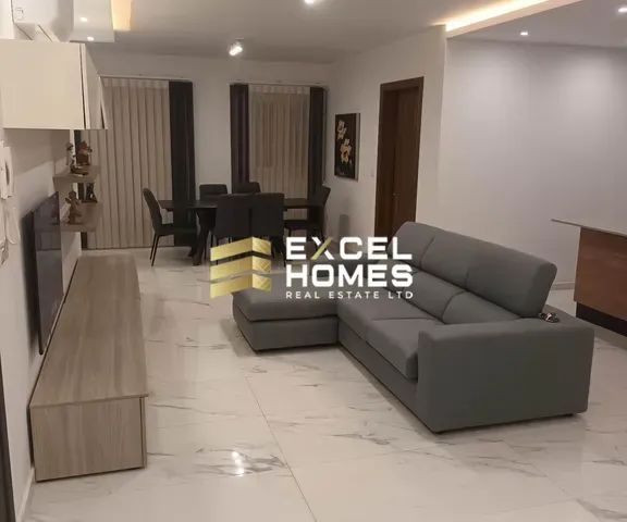 a living room with a couch, coffee table and a television