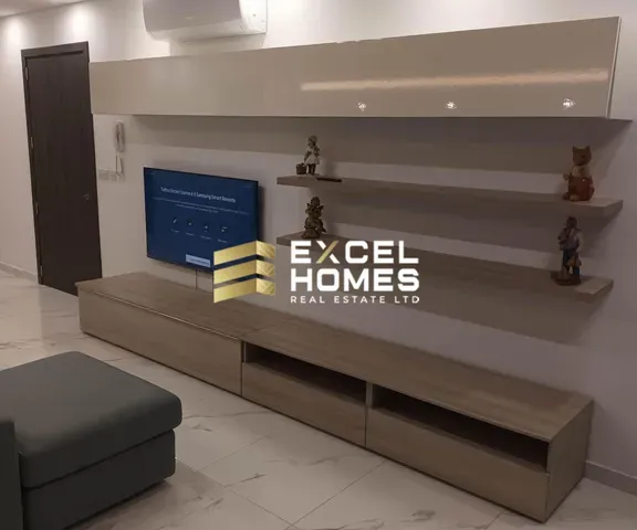 a room with a shelf with a picture of a woman on it