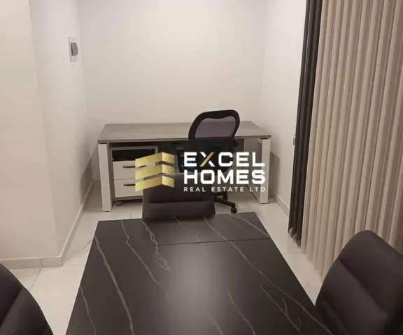 a desk with a laptop and a chair