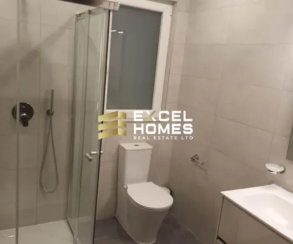 a bathroom with a toilet and a shower curtain