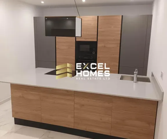 a kitchen with a sink, microwave, and refrigerator