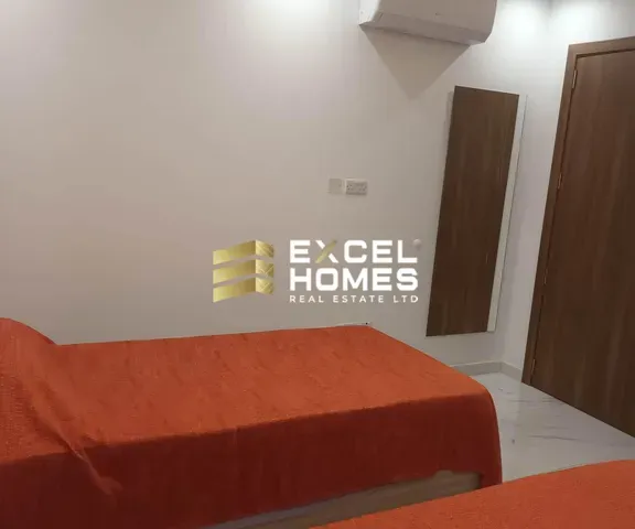 a bedroom with a bed and a desk