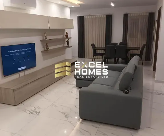 a living room with a couch, chair, and television