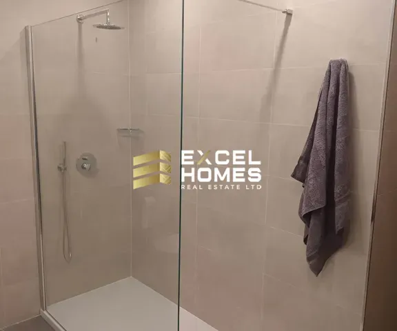 a shower stall with a towel rack and a shower curtain