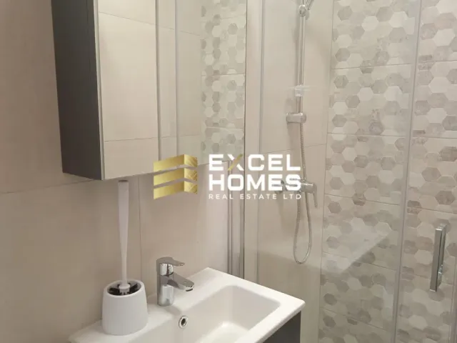 a bathroom with a shower, sink, and mirror