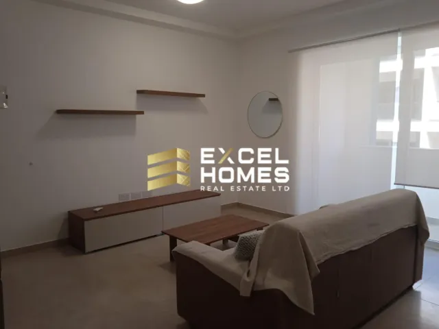 a living room with a couch and a lamp