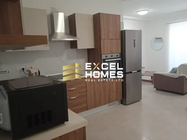 a kitchen with a refrigerator, stove, sink and a microwave