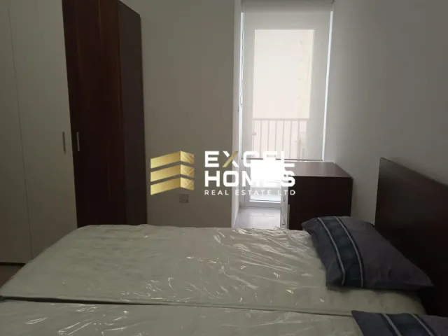 a bed with a white bedspread and a white comforter