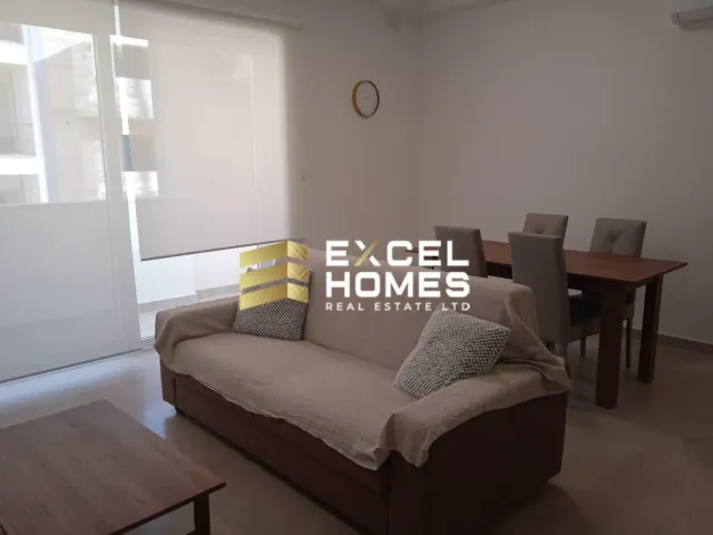 a living room with a couch, coffee table and a bookcase