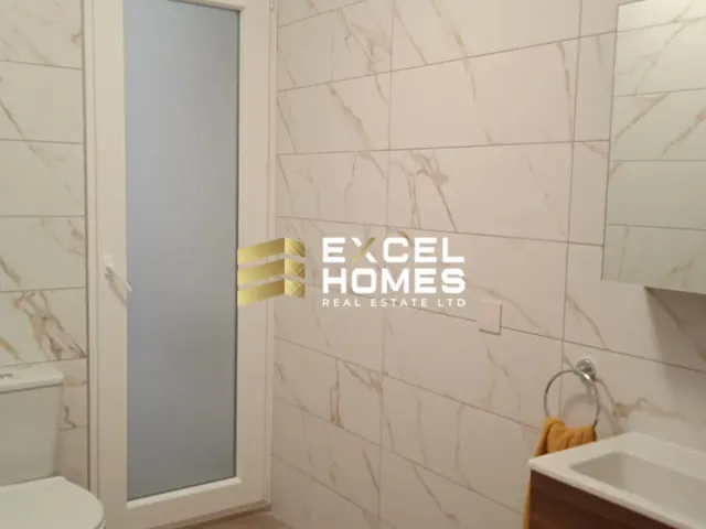 a bathroom with a white toilet and a blue wall