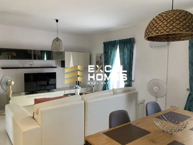 a kitchen with a table, chairs, and a lamp