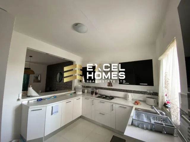 a kitchen with a television and a refrigerator