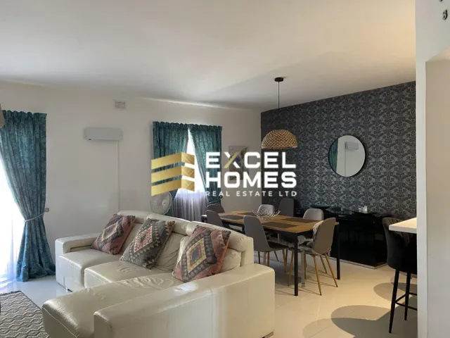 a living room with a couch, coffee table and a television