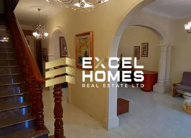 a room with a staircase and a staircase leading to a stairwell