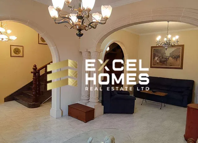 a living room with a couch, chair, and a clock