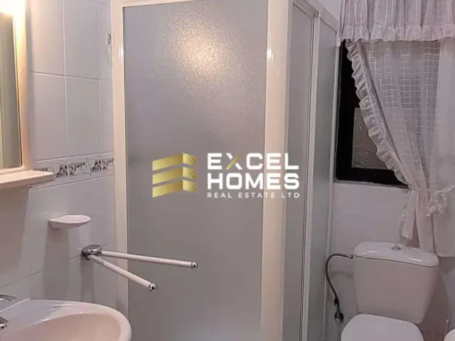 a bathroom with a toilet and a shower curtain