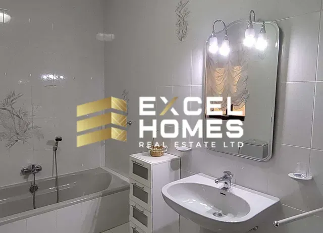 a bathroom with a sink, mirror, and bathtub